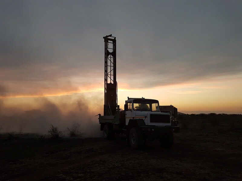 drilling truck with moody sunset