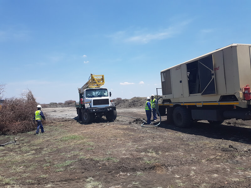 people working with a truck and a trailer